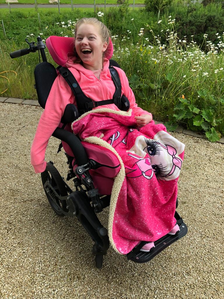 Lauren sitting in Chunc One wheelchair enjoying the outdoors.