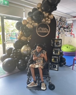 Paige seated for her graduation ceremony in her Hilo Indoor/Outdoor Chunc chair